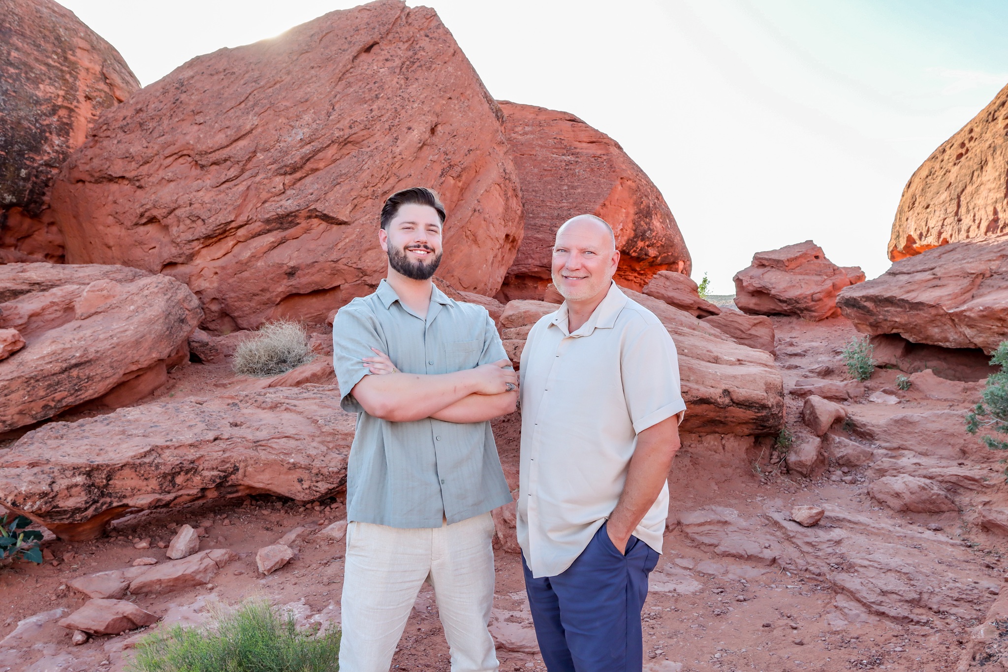 Dave and Riker McKelleb, instructors at Zion View Driving School, standing among red rocks in Southern Utah